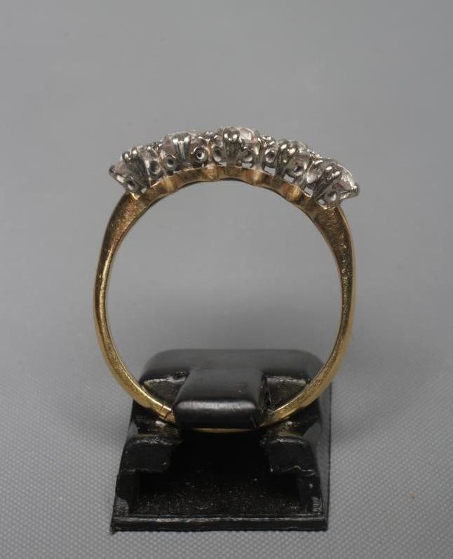 A FIVE STONE DIAMOND RING, the old cut stones each of approximately 0.20cts, claw set to plain Image