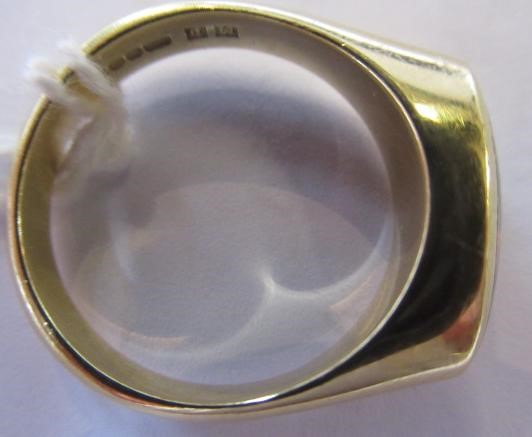 A BLACK OPAL RING, the eliptical polished stone in a rub-over setting to a plain 18ct gold shank, Image