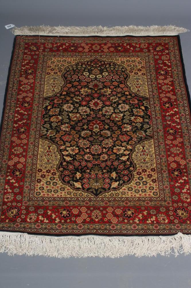 A PERSIAN SILK RUG, modern, the indigo floral field in shades of pink and pale green, the ivory Image