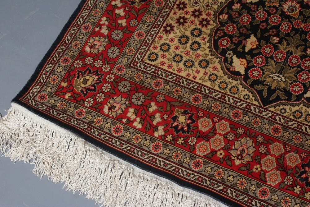 A PERSIAN SILK RUG, modern, the indigo floral field in shades of pink and pale green, the ivory Image