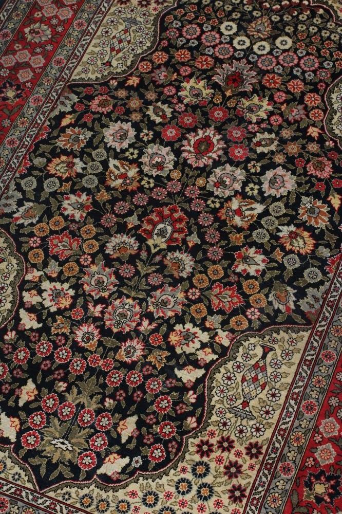 A PERSIAN SILK RUG, modern, the indigo floral field in shades of pink and pale green, the ivory Image