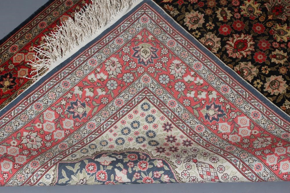 A PERSIAN SILK RUG, modern, the indigo floral field in shades of pink and pale green, the ivory Image