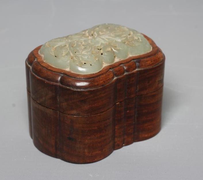 A CHINESE JADE PANEL of shaped rounded oblong form, carved and pierced with a lotus flower, 2 1/4" x Image