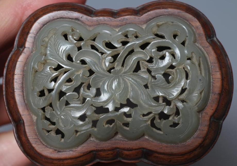 A CHINESE JADE PANEL of shaped rounded oblong form, carved and pierced with a lotus flower, 2 1/4" x Image