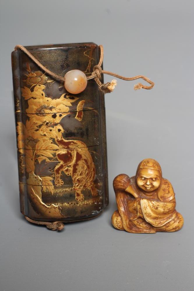 A JAPANESE LACQUER FOUR CASE INRO with two Temple Dogs in landscape on a dark green ground Image