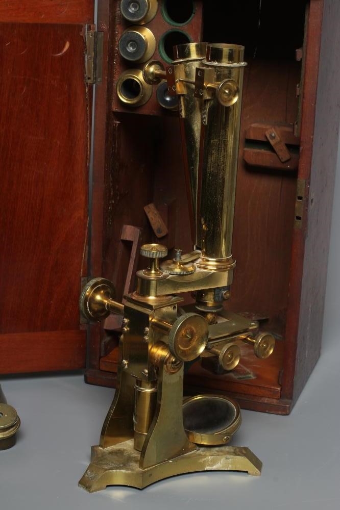 A LATE VICTORIAN BINOCULAR MICROSCOPE BY DOLLAND, LONDON with assorted optics, lenses and Image