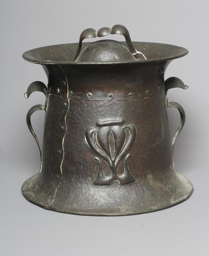 AN ART NOUVEAU COPPER TWO HANDLED COAL BIN AND COVER of swept cylindrical form with repousse Image