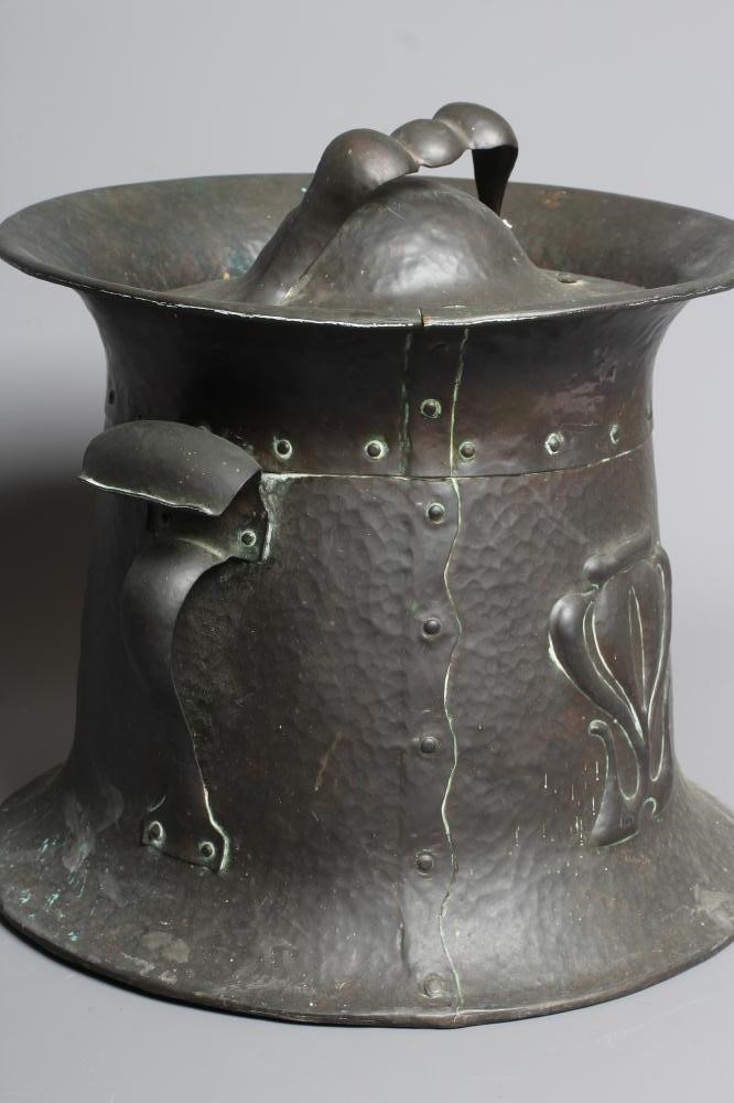 AN ART NOUVEAU COPPER TWO HANDLED COAL BIN AND COVER of swept cylindrical form with repousse Image