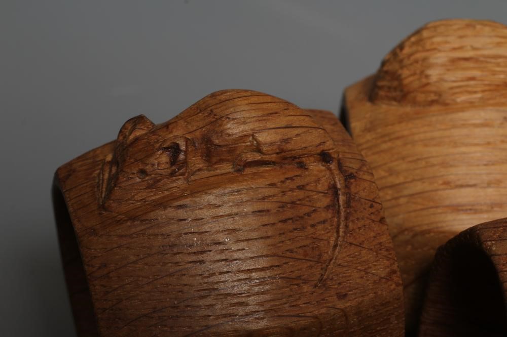 TWO ROBERT THOMPSON OAK OCTAGONAL NAPKIN RINGS each with carved mouse trademark, approximately 2" Image