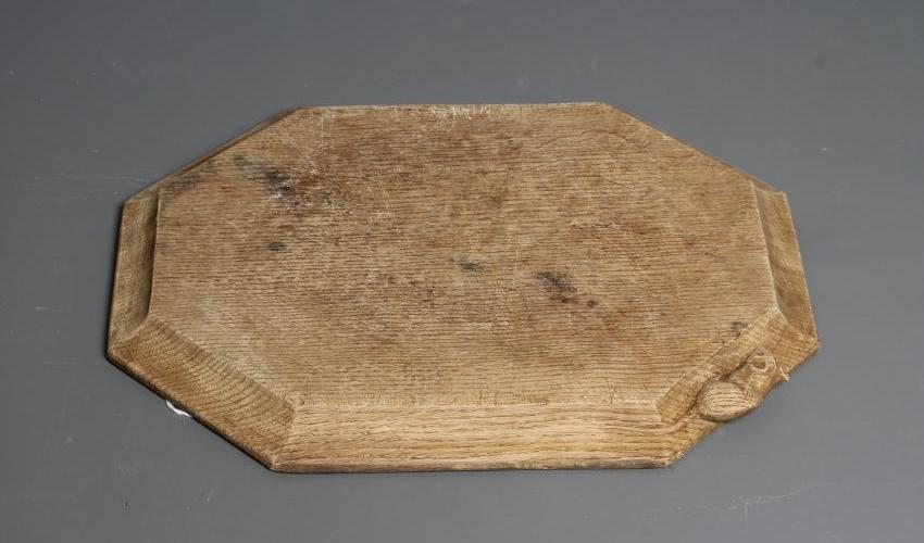 A ROBERT THOMPSON OAK OBLONG BREADBOARD with carved mouse trademark, 12" wide, 10" long (Est. plus Image