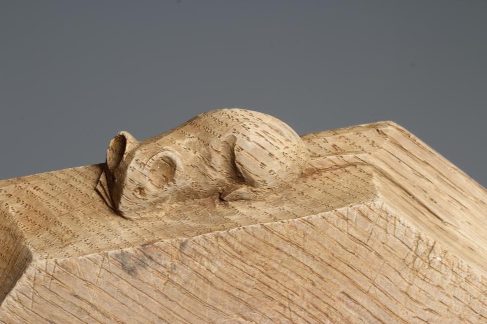 A ROBERT THOMPSON OAK OBLONG BREADBOARD with carved mouse trademark, 12" wide, 10" long (Est. plus Image