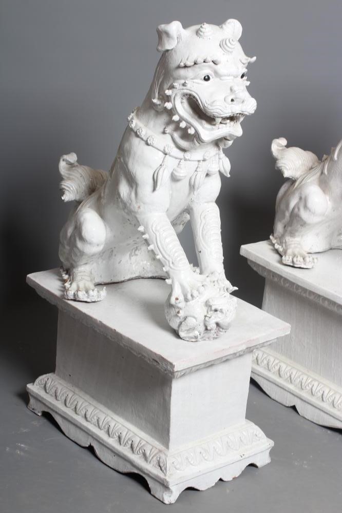 A LARGE PAIR OF WHITE CRACKLE GLAZED TERRACOTTA TEMPLE LIONS Image