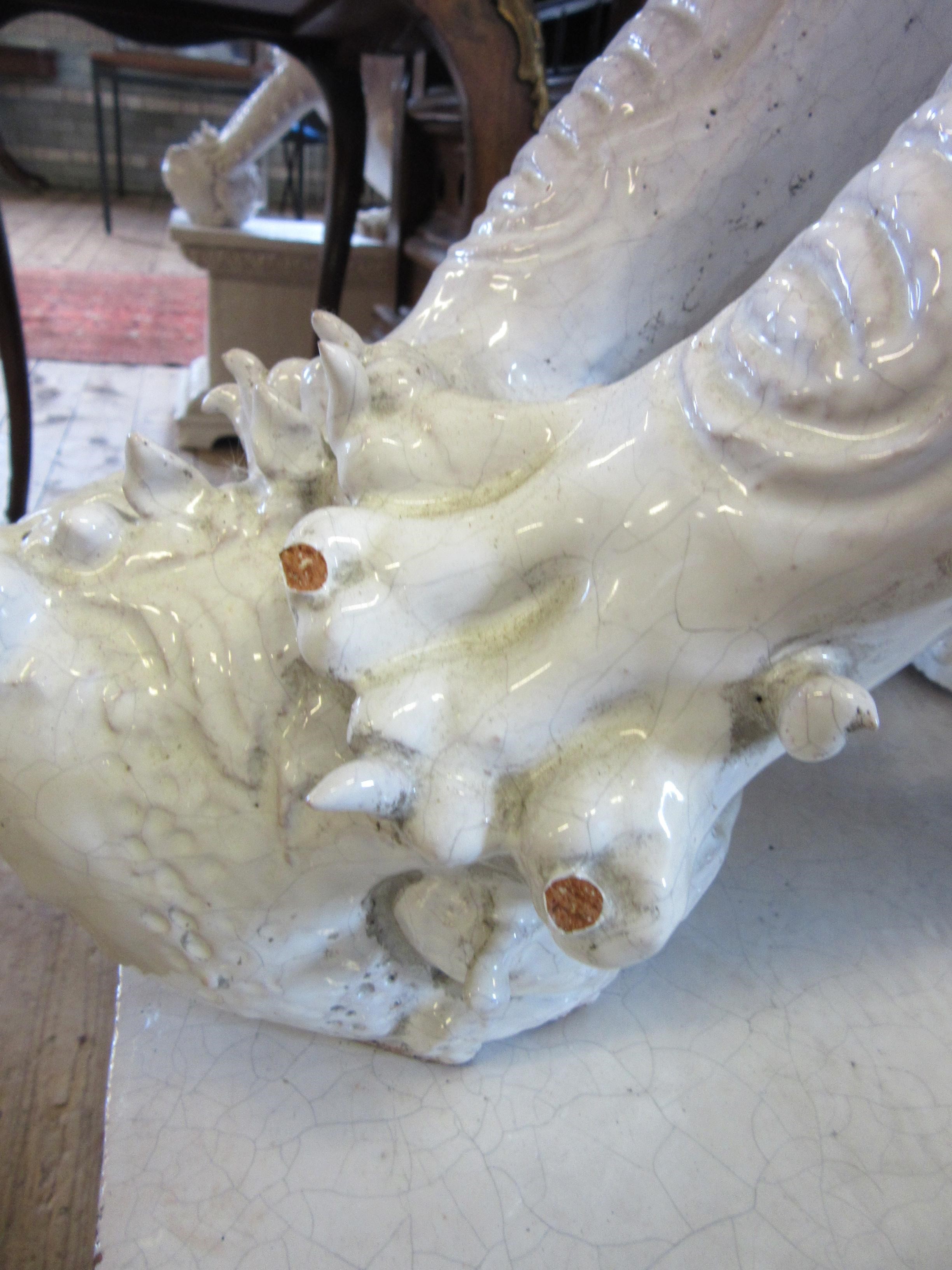 A LARGE PAIR OF WHITE CRACKLE GLAZED TERRACOTTA TEMPLE LIONS Image