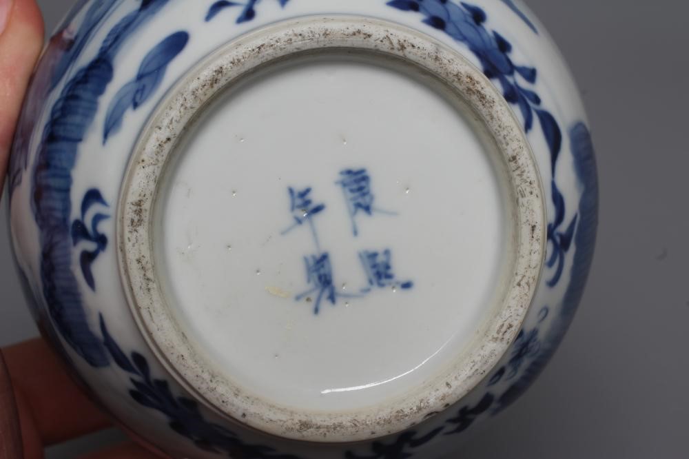 A CHINESE PORCELAIN GOURD VASE painted in underglaze blue with a river landscape with two figures Image