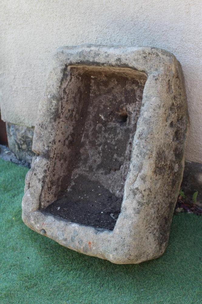 A SANDSTONE TROUGH of rough-hewn oblong form mildly tapering towards the front, 30" w x 19 1/2" d x Image
