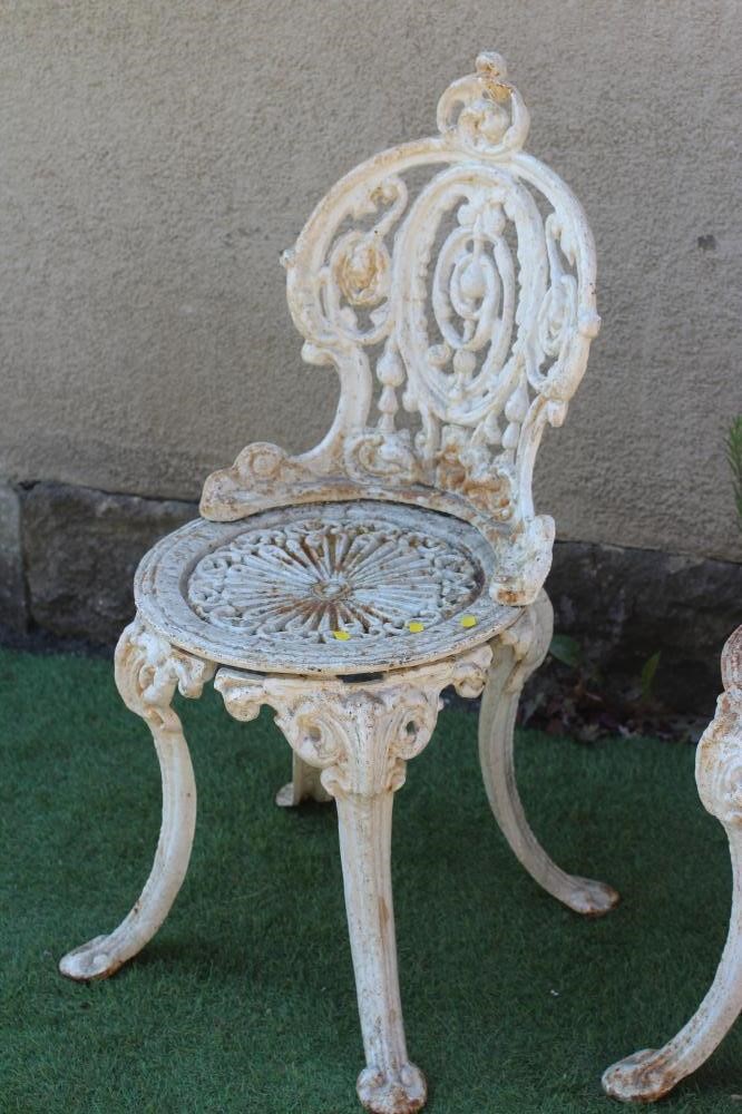 A PAIR OF VICTORIAN CAST IRON CHAIRS in Coalbrookdale design, the waisted medallion back over Image