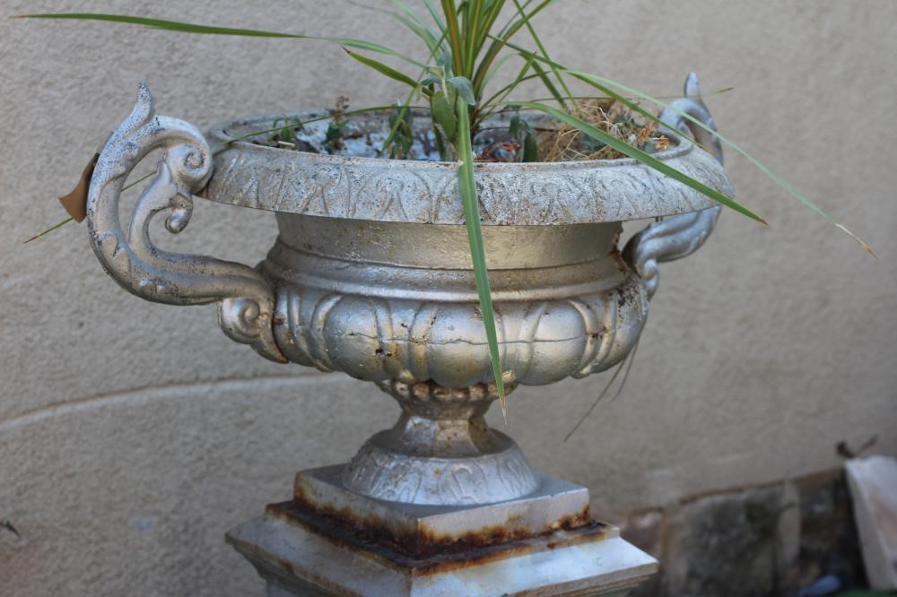 A CAST METAL URN ON STAND Image