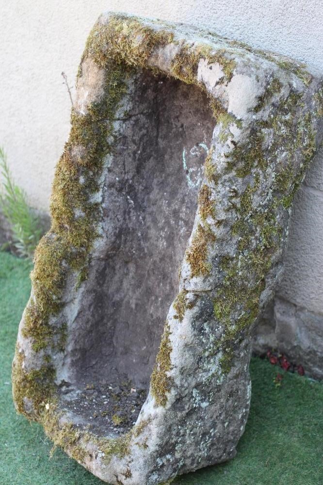 A SANDSTONE TROUGH of rough-hewn oblong form, 36 1/2" w x 18" d x 10 1/2" h (Est. plus 24% premium Image