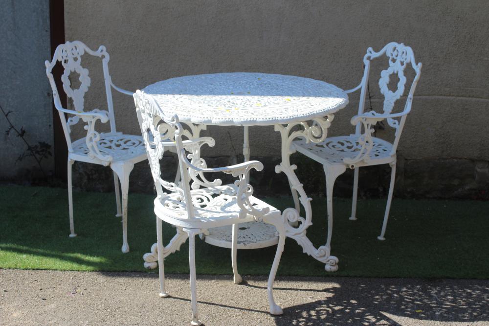 A CAST METAL TABLE AND CHAIRS Image