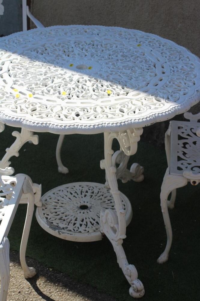 A CAST METAL TABLE AND CHAIRS Image