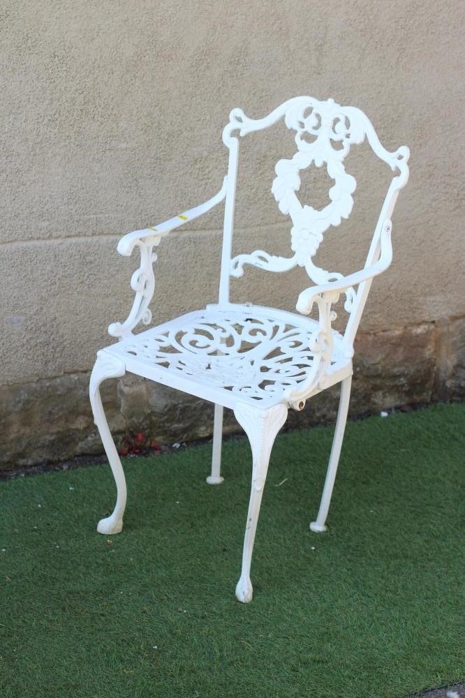 A CAST METAL TABLE AND CHAIRS Image