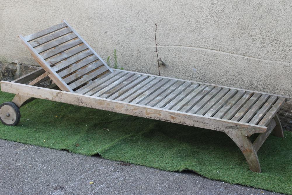 A SLATTED HARDWOOD SUN LOUNGER, modern, with folding adjustable back, on square section legs and Image