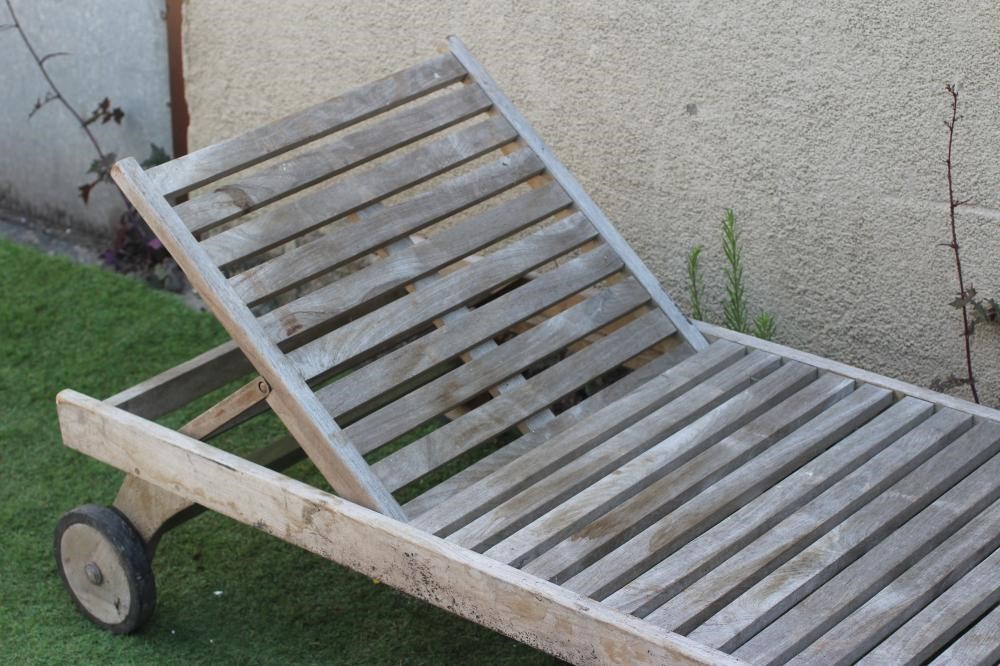 A SLATTED HARDWOOD SUN LOUNGER, modern, with folding adjustable back, on square section legs and Image