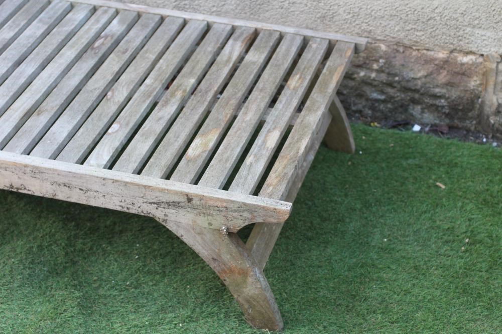 A SLATTED HARDWOOD SUN LOUNGER, modern, with folding adjustable back, on square section legs and Image