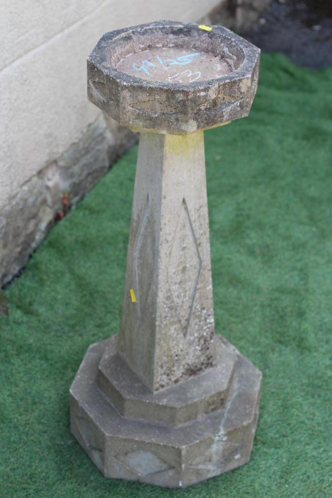 AN ART DECO STYLE HEXAGONAL SANDSTONE BIRDBATH with square tapering stem and carved with recessed Image