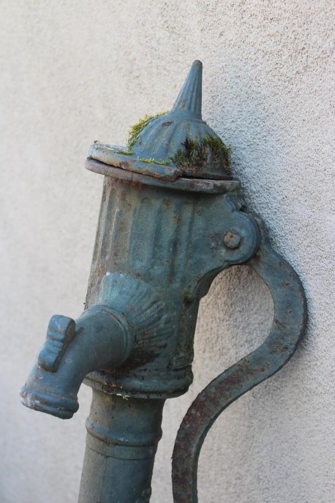 A VICTORIAN CAST IRON WATER PUMP with spike finial, on reeded dome lid and collared cylindrical Image