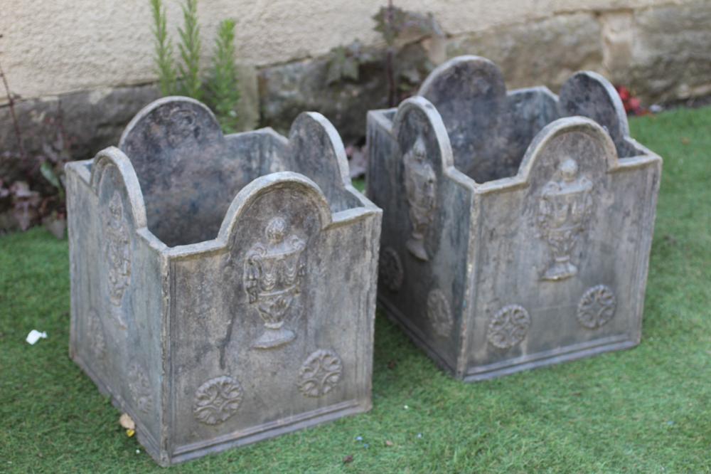 A PAIR OF WEATHERED LEAD SQUARE PLANTERS, the arched moulded sides cast in relief with draped Image