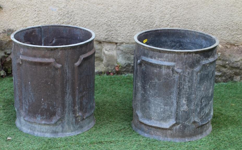 A PAIR OF WEATHERED LEAD CYLINDRICAL PLANTERS, the sides cast with outline cut corner panels, 13 Image