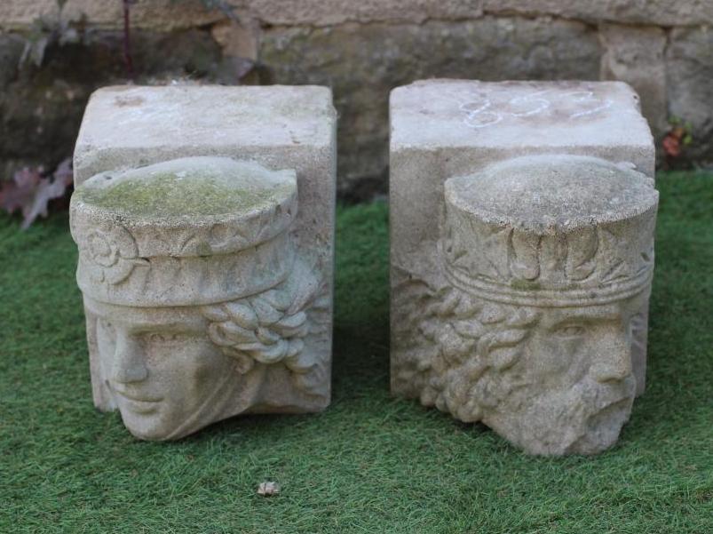 A PAIR OF CAST STONE FIGURAL CORBELS, modelled as King and Queen heads, 8 1/4" w x 12" d x 9 1/2" h Image