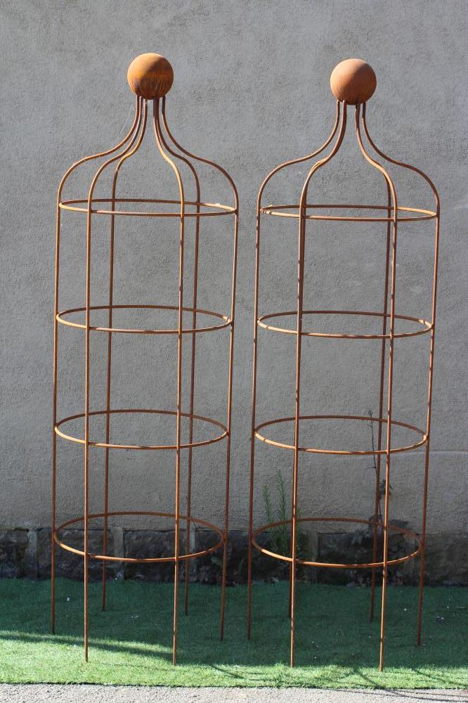 A PAIR OF WROUGHT IRON "WINDSOR PATTERN" CYLINDRICAL PLANT OBELISKS, the top of curved outline with Image