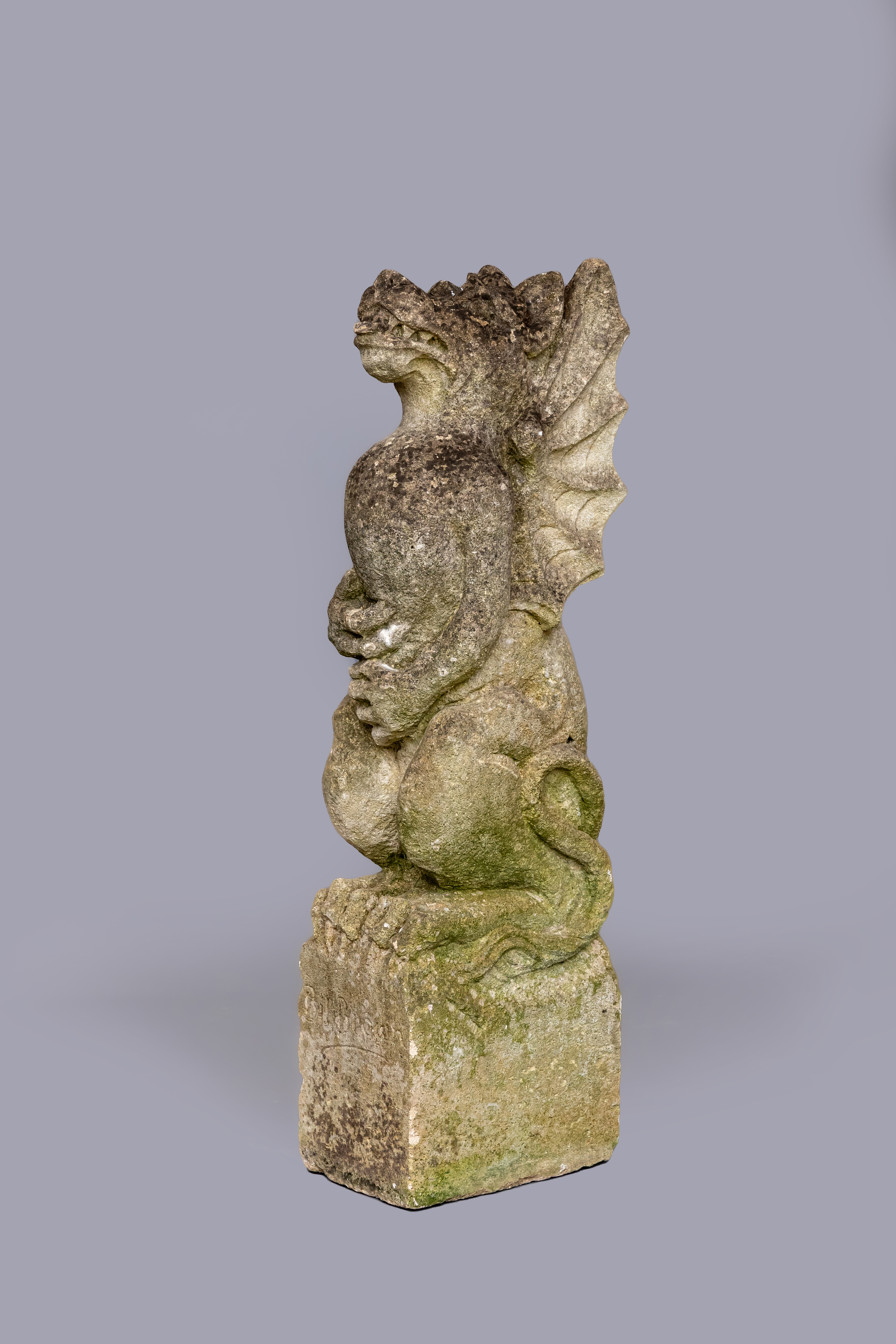 A CARVED SANDSTONE GARGOYLE CORBEL modelled as a seated winged beast holding a detachable flagpole, Image