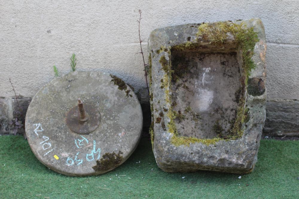 A SANDSTONE TROUGH of rough-hewn oblong form, 26" w x 20" d x 8" h, together with a grinding wheel, Image