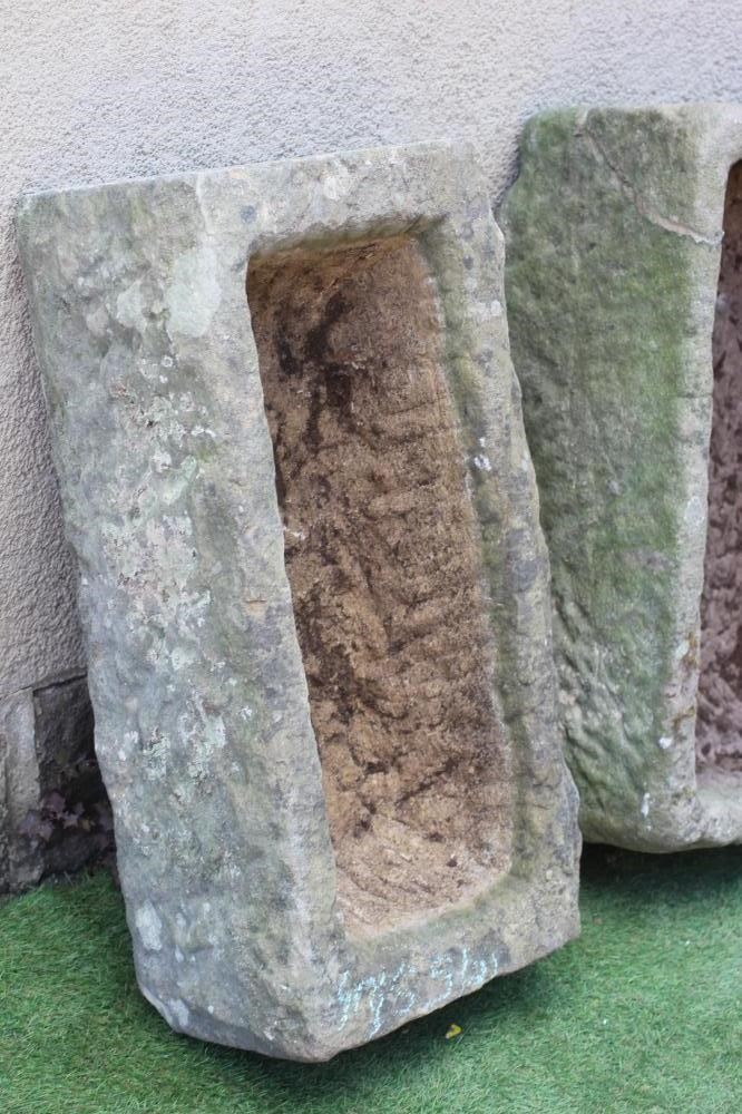 TWO SANDSTONE TROUGHS of rough-hewn oblong form, 29 1/2" w x 14 1/2" d x 9" h, and 29" w x 17 1/2" d Image