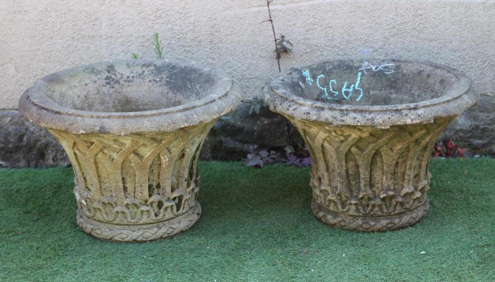 A PAIR OF CAST STONE PLANTERS, the moulded everted rim over a tapering body with gothic arcading, 24 Image