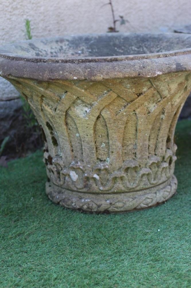 A PAIR OF CAST STONE PLANTERS, the moulded everted rim over a tapering body with gothic arcading, 24 Image