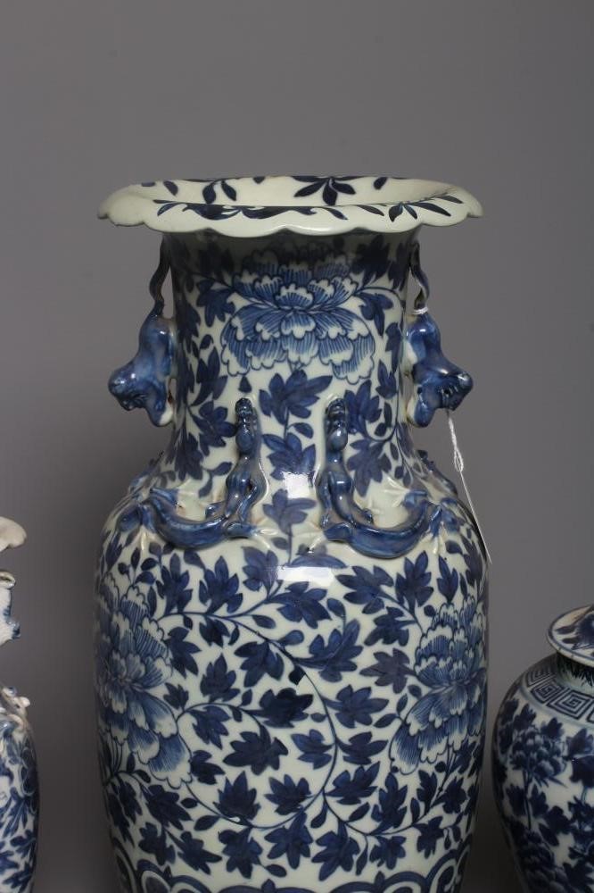 A CHINESE PORCELAIN JAR AND COVER of inverted baluster form painted in underglaze blue with two four Image