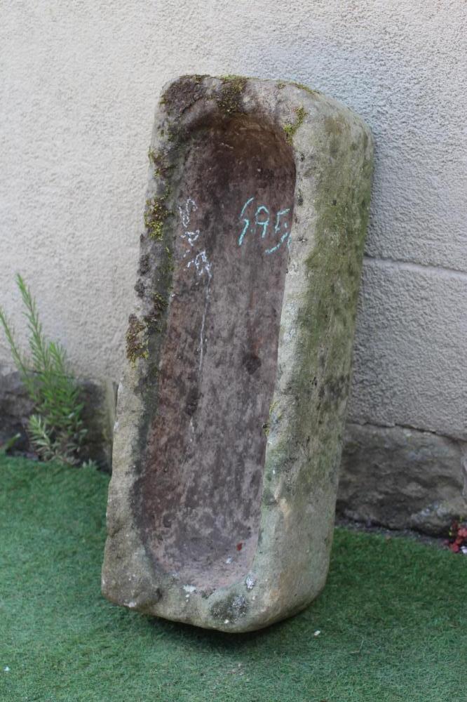A SANDSTONE TROUGH of rough-hewn oblong form, 35" w x 13" d x 8 1/2" h (Est. plus 24% premium inc. Image