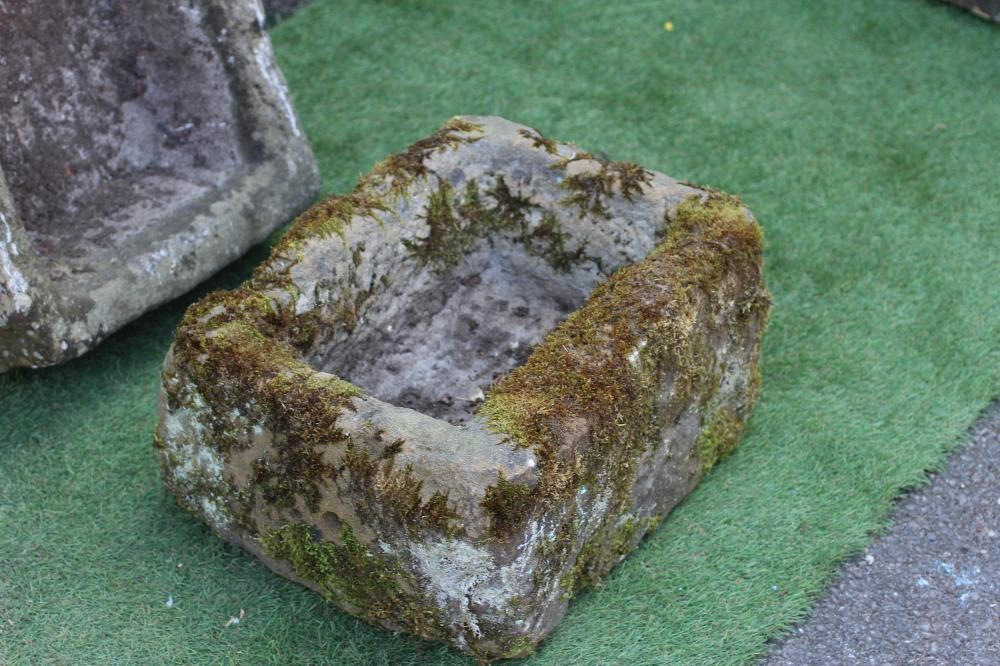 A SANDSTONE TROUGH of rough-hewn oblong form, 26" w x 16" d x 8 1/2" h, together with a similar Image
