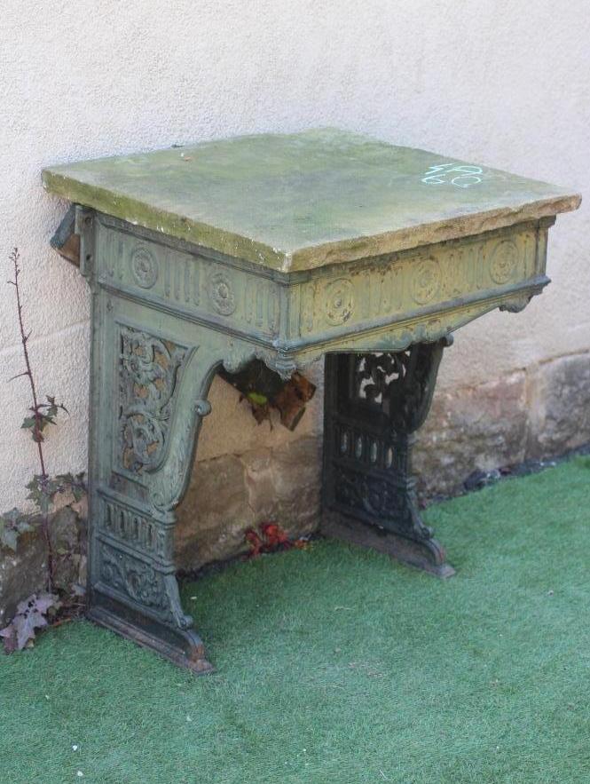 A VICTORIAN CAST IRON STAND, the fluted frieze with rosettes, raised on pierced scrolling foliate Image