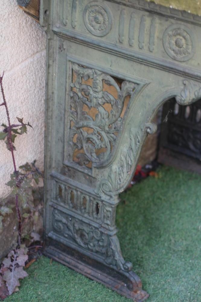 A VICTORIAN CAST IRON STAND, the fluted frieze with rosettes, raised on pierced scrolling foliate Image