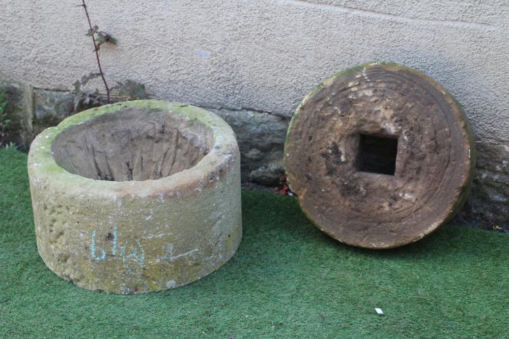A SANDSTONE PLANTER of cylindrical form, finely cut, 19 1/2" w x 10 1/4" h, together with a small Image