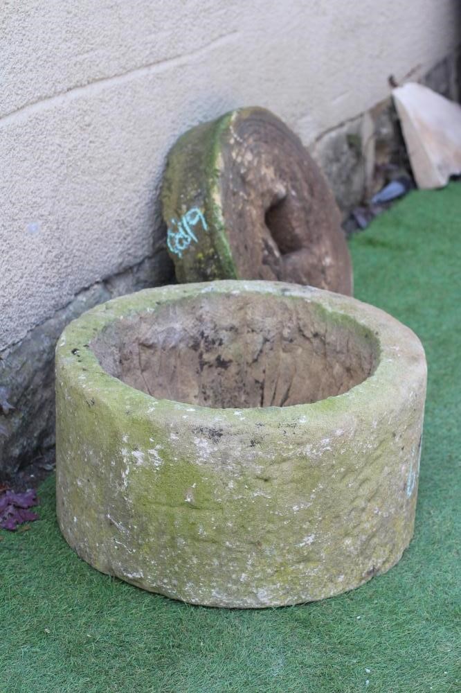 A SANDSTONE PLANTER of cylindrical form, finely cut, 19 1/2" w x 10 1/4" h, together with a small Image