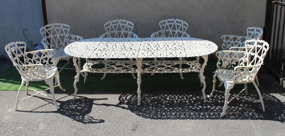 A CAST METAL TABLE AND CHAIRS Image