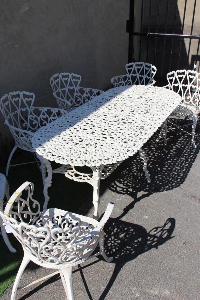 A CAST METAL TABLE AND CHAIRS Image