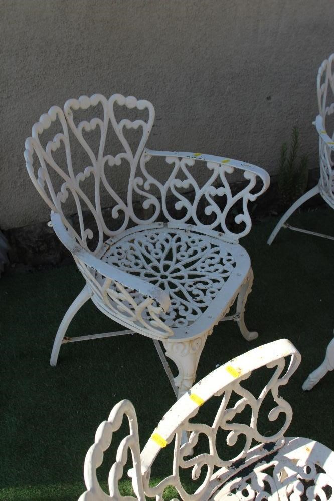 A CAST METAL TABLE AND CHAIRS Image
