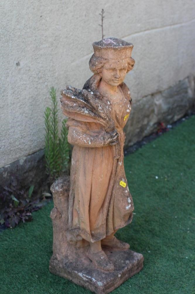 A CAST RED STONE FEMALE FIGURE allegorical of Autumn, modelled standing and holding a corn sheaf, on Image